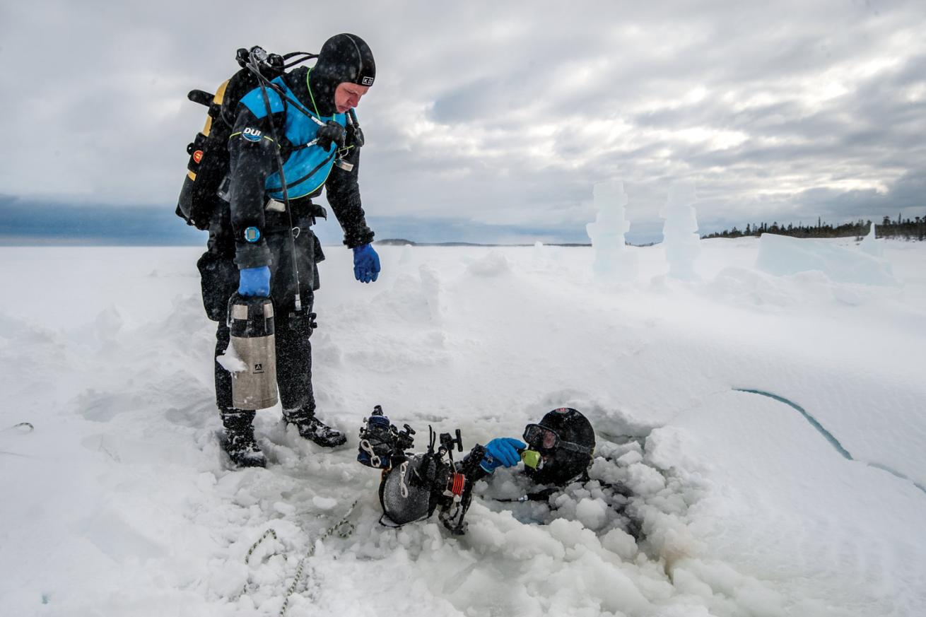 Divers in frozen water