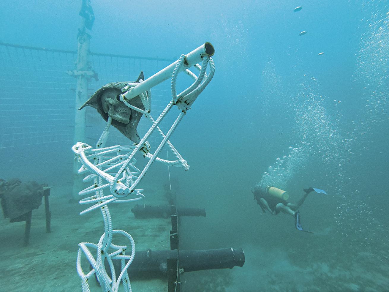 A pirate skeleton keeps watch over cannons at the stern of the *Willy T*.